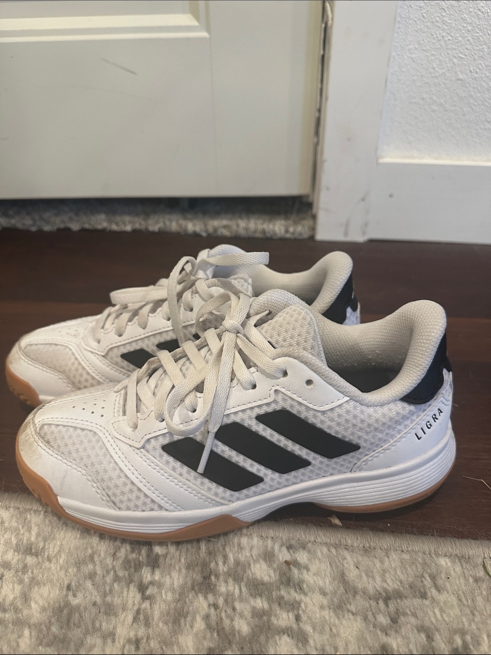 adidas Ligra Volleyball Kids White tennis shoes with Black Stripes and Gum Sole
